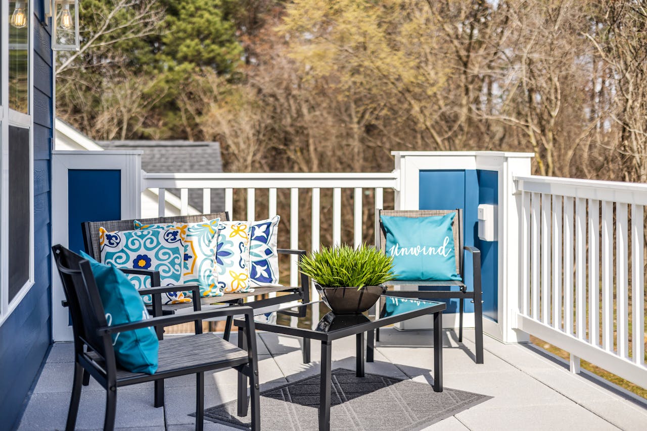 Inviting outdoor terrace with stylish chairs and colorful cushions, perfect for relaxation.